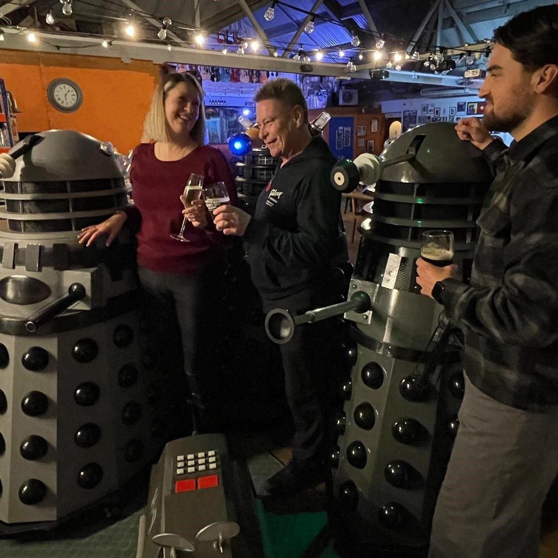 Guests enjoying a photo opportunity with screen-accurate Dalek replicas at a UK corporate event, available for Doctor Who themed prop hire.